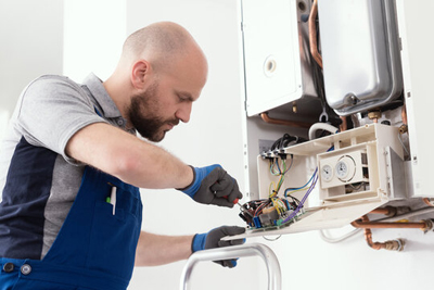 gas-engineer-repairing-boiler